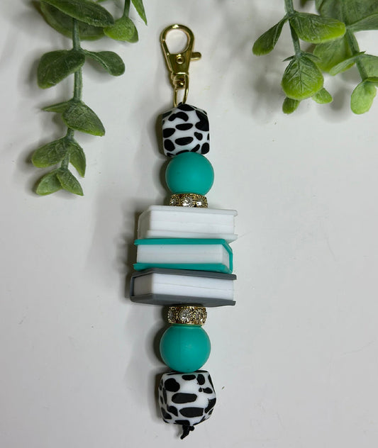 Turquoise Cow Print Book Keychain